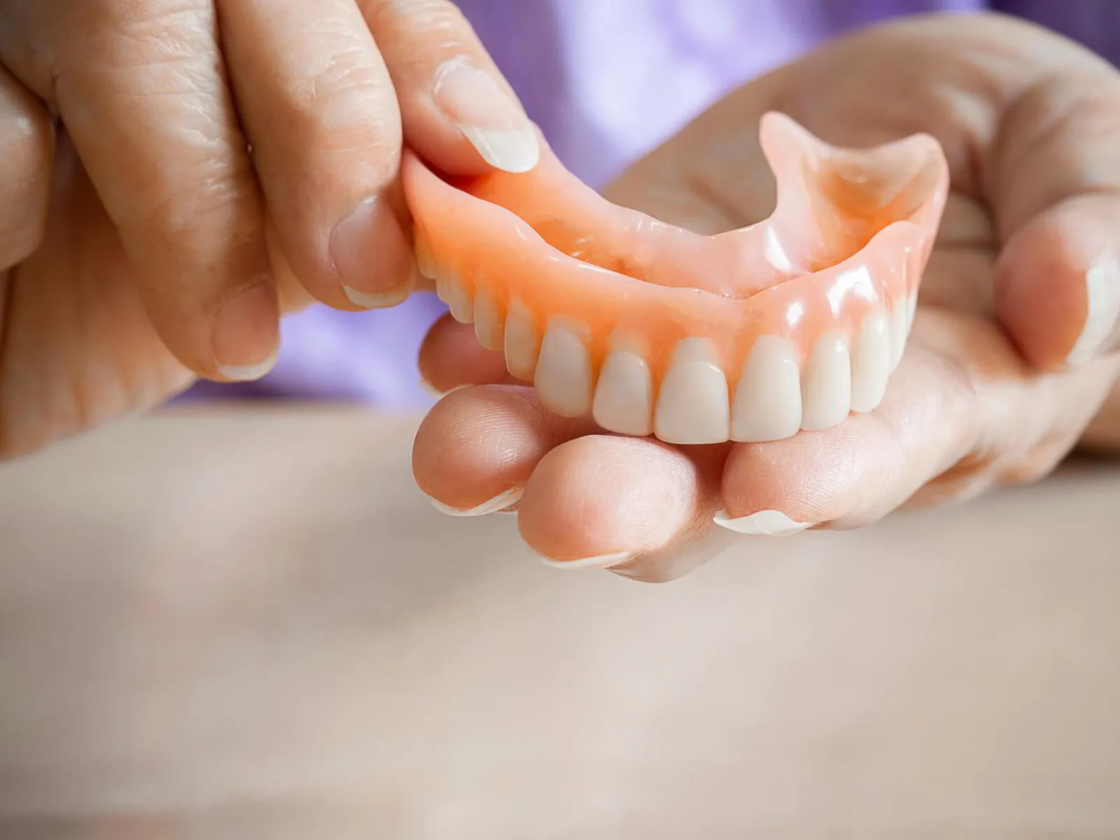 A complete denture resting on a smooth, well-prepared model of the jaw ridge